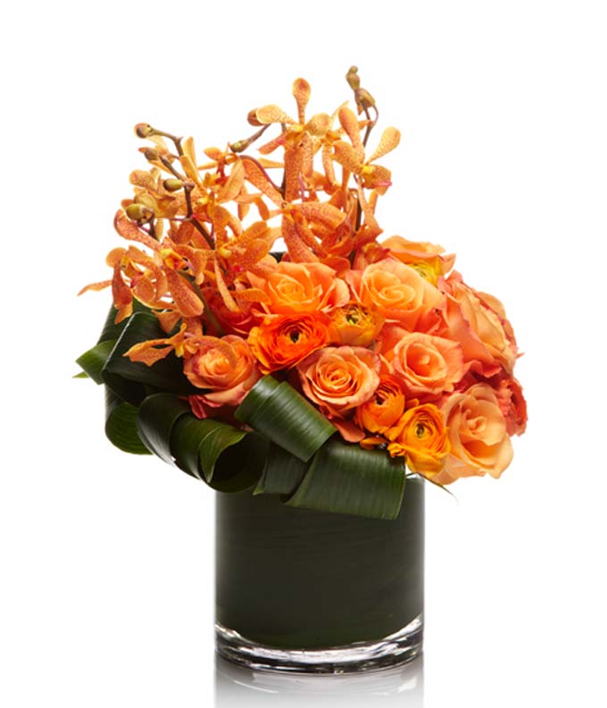 Luxury Arrangement of Orange Roses, Ranunculus, and Mokara Orchids.  
