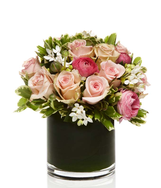 A beautiful mix of premium pink roses artfully arranged in a chic glass vase.