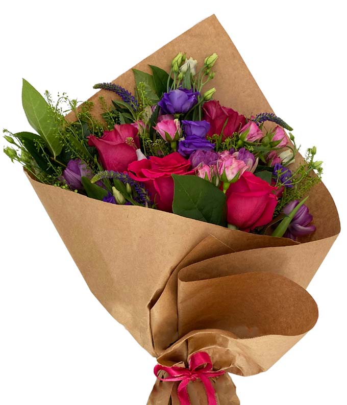 Soft blooms in various hues of red, pink, and purple wrapped in brown kraft paper