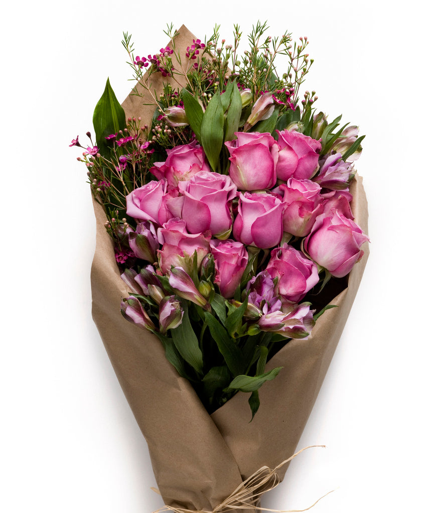 Pink and Purple Roses and Seasonal Flowers wrapped in a neat bundle - H.Bloom