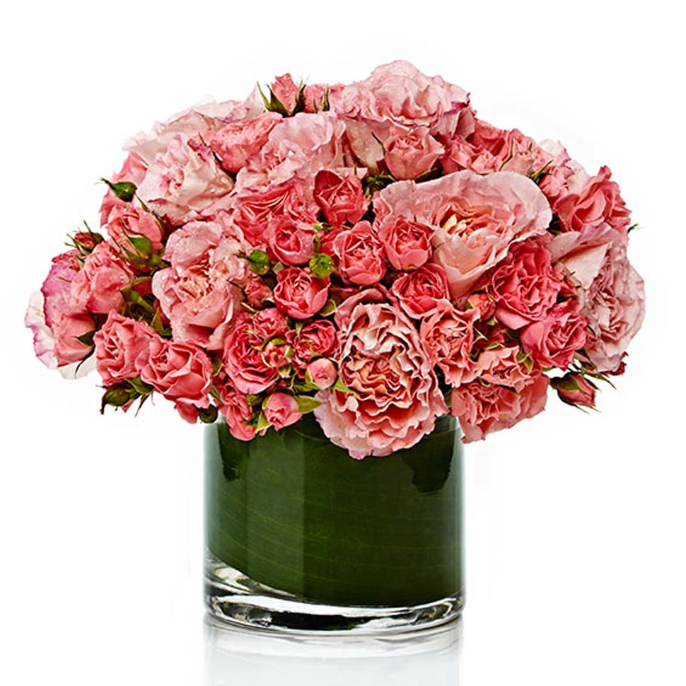A chic mixed arrangement of assorted pink rose varieties arranged neatly in a premium glass vase.